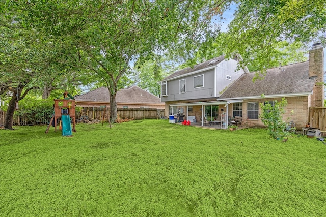 view of yard featuring a playground and a patio