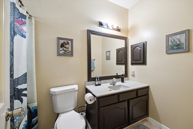 bathroom featuring vanity, tile patterned flooring, and toilet