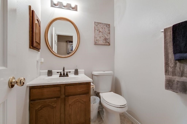 bathroom with tile patterned flooring, toilet, and vanity