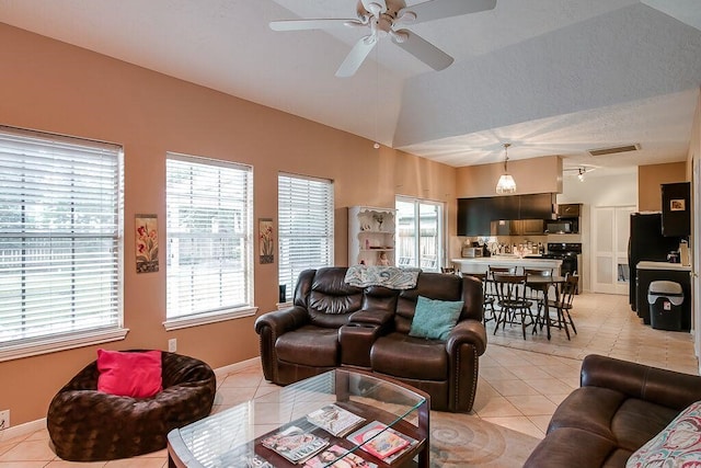 living room with light tile patterned flooring, a healthy amount of sunlight, and ceiling fan