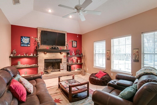 living room featuring a fireplace, tile patterned flooring, ceiling fan, lofted ceiling, and a tray ceiling