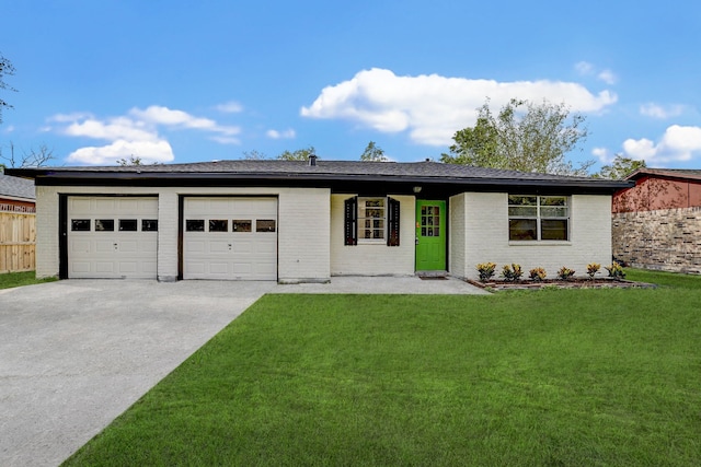 ranch-style home featuring a garage and a front lawn