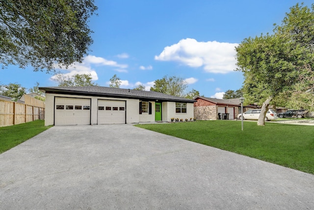 ranch-style home featuring a garage and a front lawn