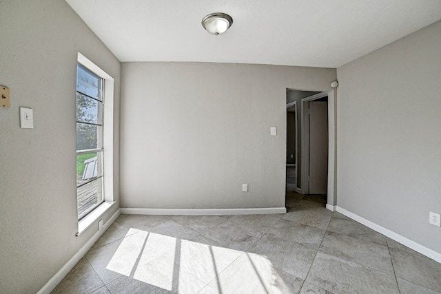 spare room featuring light tile patterned floors