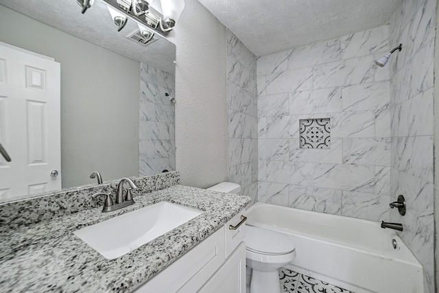 full bathroom featuring tile patterned floors, vanity, tiled shower / bath combo, and toilet