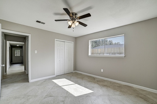 unfurnished bedroom with a closet, ceiling fan, and light tile patterned floors