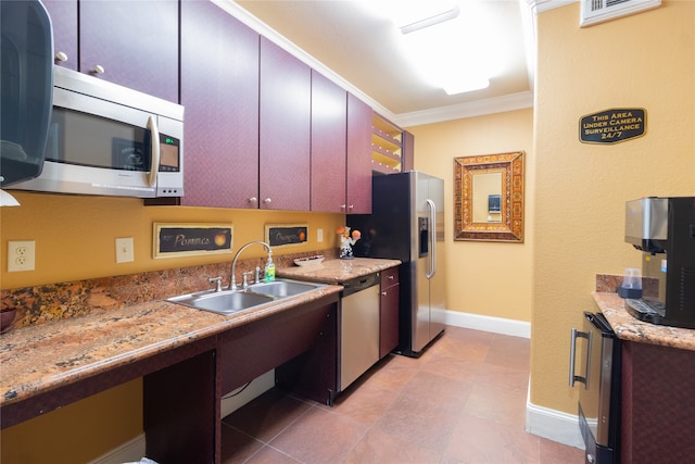 kitchen with ornamental molding, sink, light tile patterned floors, and appliances with stainless steel finishes