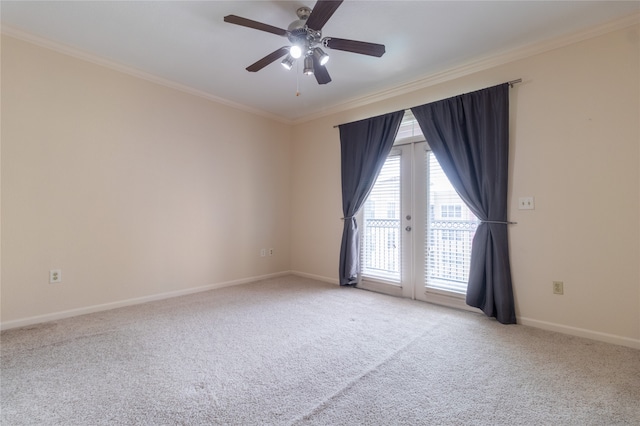 spare room with crown molding, light carpet, ceiling fan, and french doors