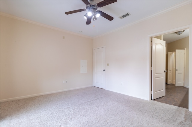 unfurnished bedroom with light colored carpet, ornamental molding, and ceiling fan