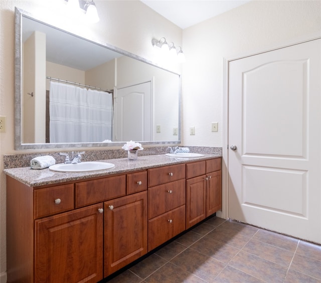 bathroom with tile patterned floors and double sink vanity