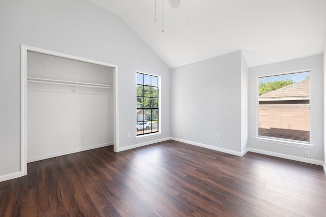 unfurnished bedroom featuring wood-type flooring, a closet, and high vaulted ceiling