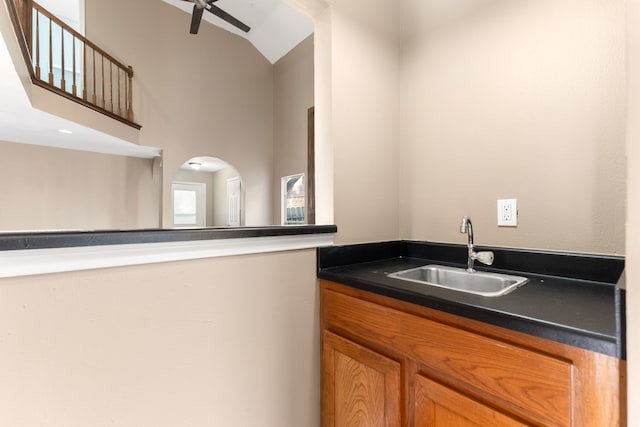 bathroom featuring ceiling fan, a high ceiling, and vanity