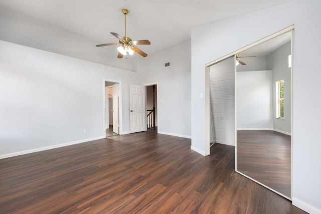 unfurnished bedroom with high vaulted ceiling, visible vents, baseboards, a closet, and dark wood finished floors