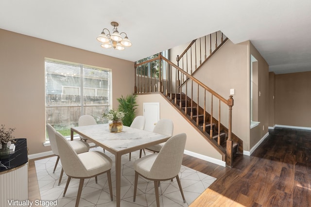 dining area featuring an inviting chandelier, a healthy amount of sunlight, and hardwood / wood-style floors