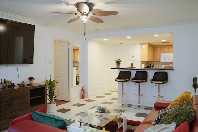 living room featuring light tile patterned flooring, crown molding, and ceiling fan