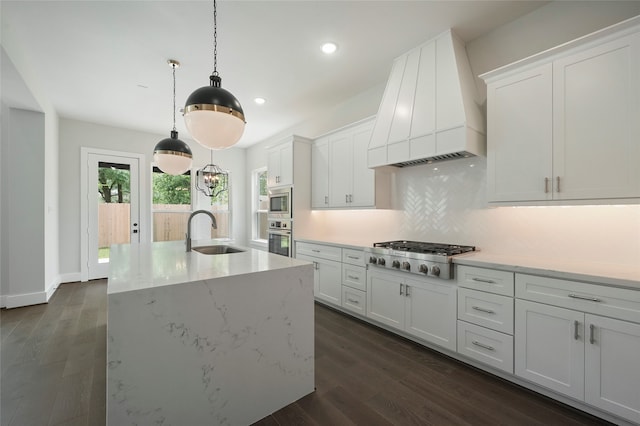 kitchen with premium range hood, stainless steel appliances, sink, and white cabinets