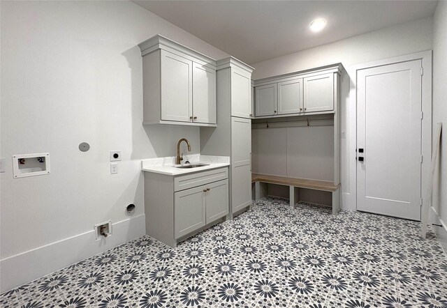 clothes washing area with cabinets, hookup for a gas dryer, sink, hookup for a washing machine, and hookup for an electric dryer