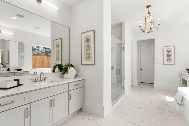 bathroom featuring a chandelier, vanity, marble finish floor, and a marble finish shower