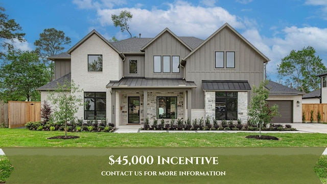 view of front of property featuring a standing seam roof, a garage, fence, and a front lawn