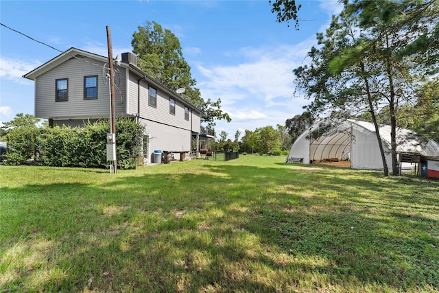 view of yard featuring an outdoor structure and central AC unit