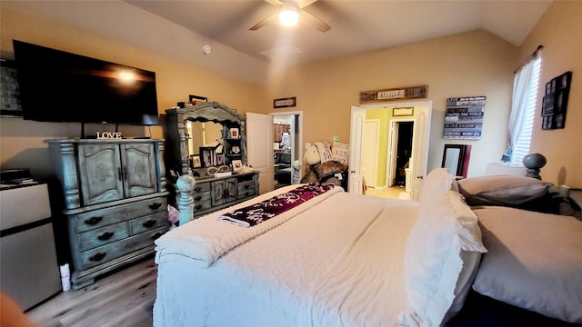 bedroom featuring hardwood / wood-style flooring, vaulted ceiling, and ceiling fan