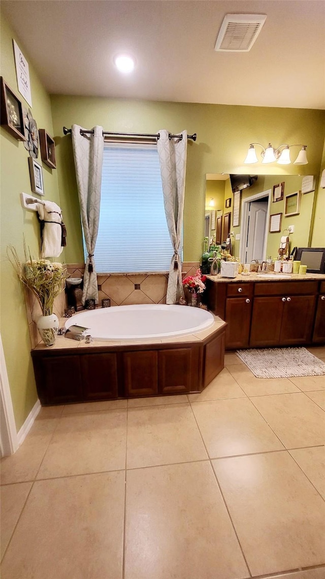 bathroom featuring vanity, a bath, and tile patterned flooring