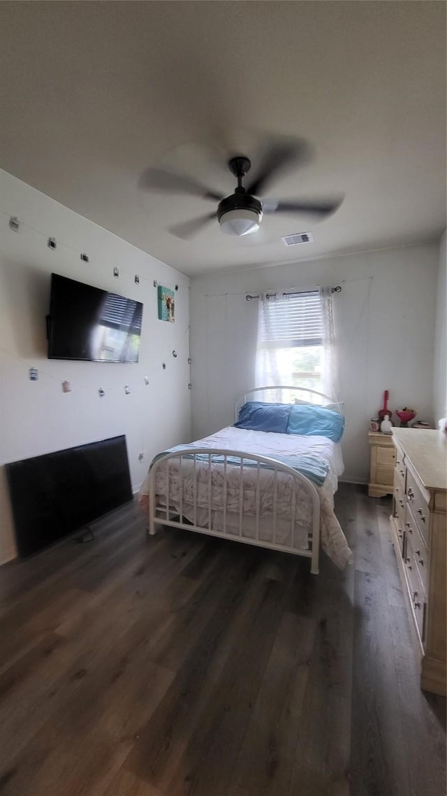 bedroom with ceiling fan and dark hardwood / wood-style flooring