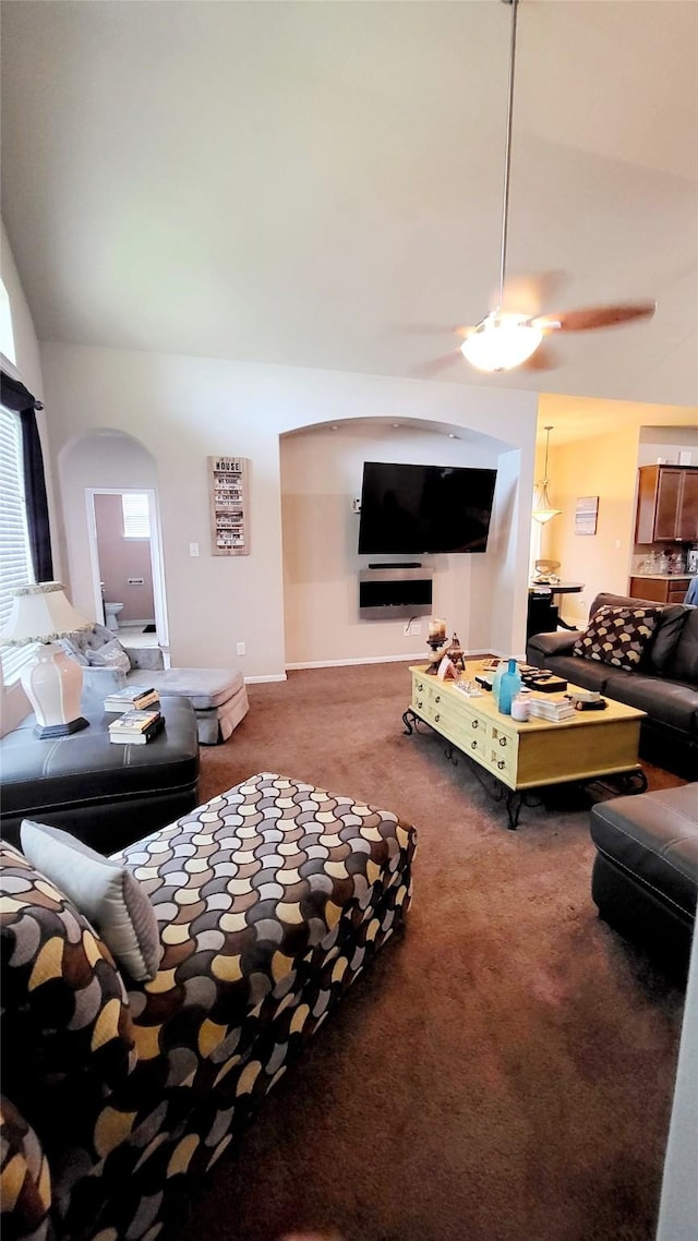 living room with vaulted ceiling and dark colored carpet