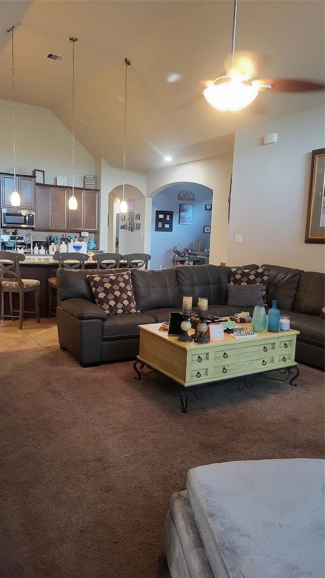 living room featuring light carpet and high vaulted ceiling