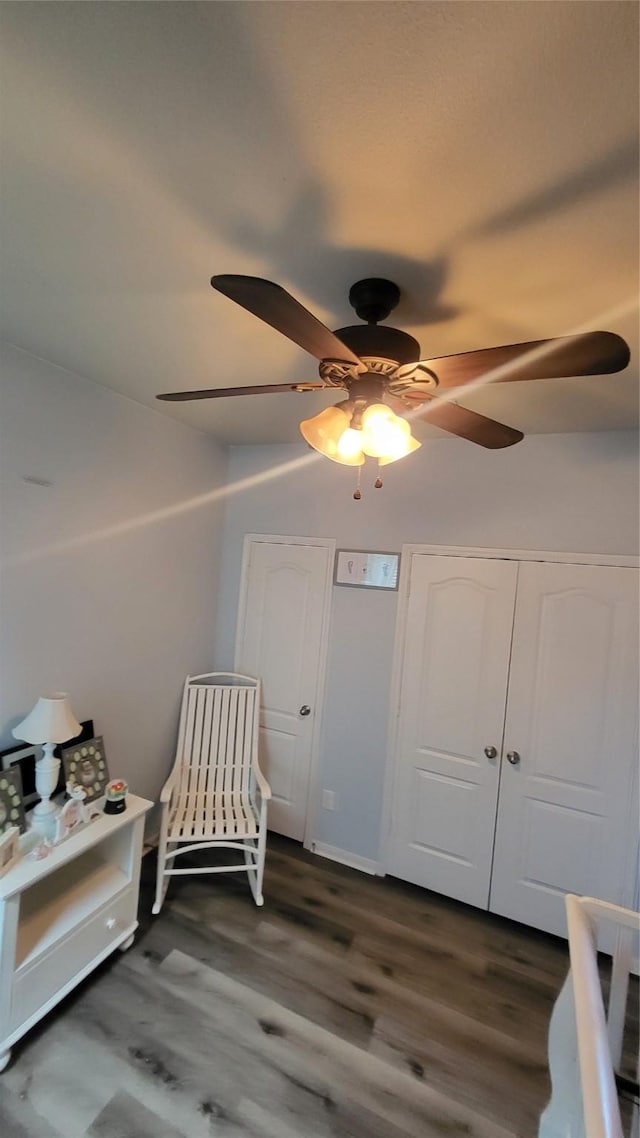 bedroom with ceiling fan and dark hardwood / wood-style flooring