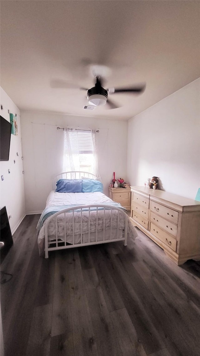 bedroom with dark wood-type flooring and ceiling fan