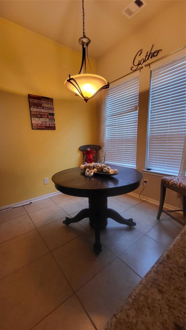 unfurnished dining area featuring tile patterned flooring