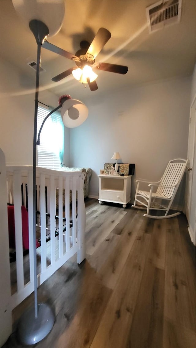 bedroom with dark hardwood / wood-style floors and ceiling fan