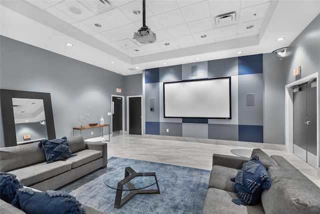 home theater room with a high ceiling and a raised ceiling