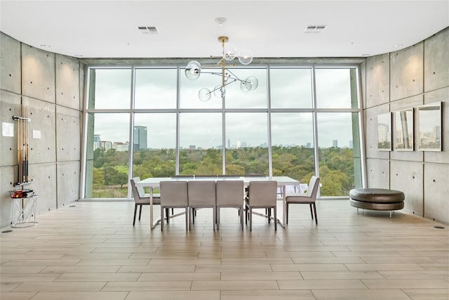 sunroom / solarium featuring an inviting chandelier and a healthy amount of sunlight