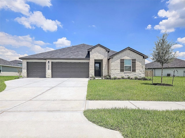 view of front of property with a garage and a front yard