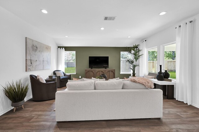 living room featuring lofted ceiling and dark hardwood / wood-style flooring