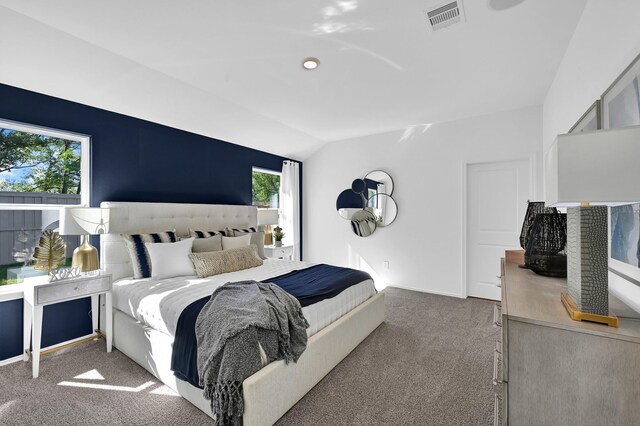 carpeted bedroom with vaulted ceiling