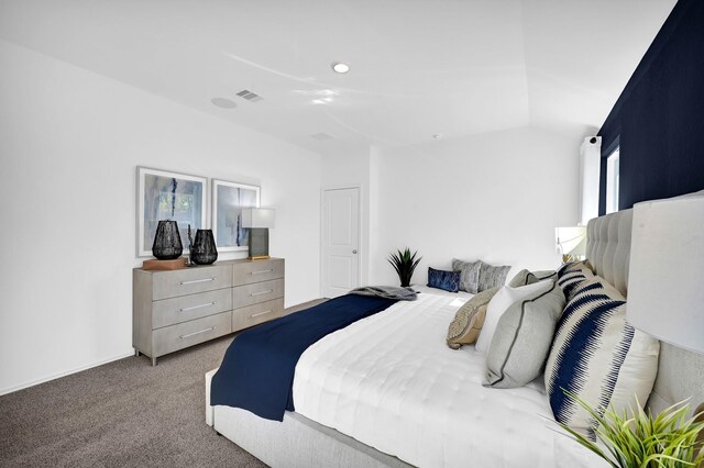 bedroom with lofted ceiling and carpet floors