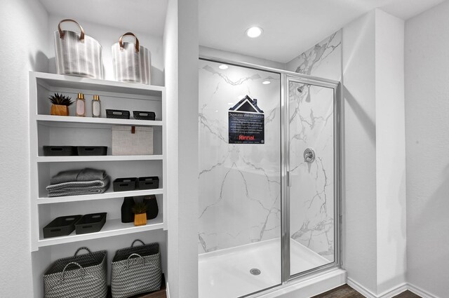 bathroom with a shower with door