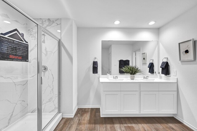 bathroom with vanity, hardwood / wood-style floors, and a shower with shower door