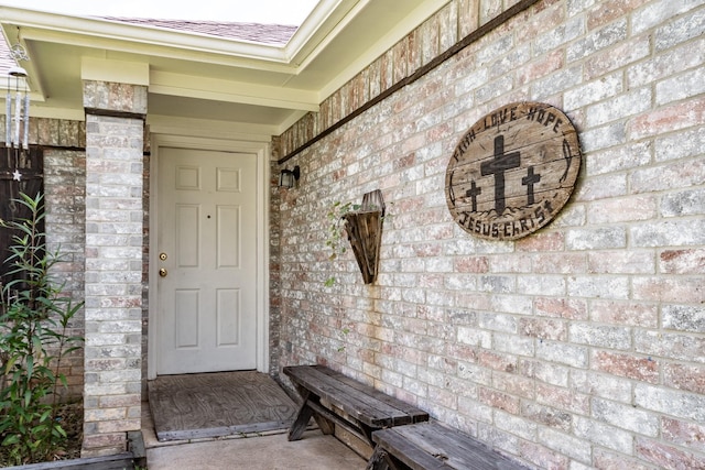 entrance to property with brick siding