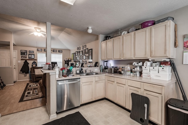 kitchen with a ceiling fan, open floor plan, light countertops, light floors, and stainless steel dishwasher