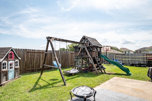 view of jungle gym with a fenced backyard, a yard, a fire pit, and a patio