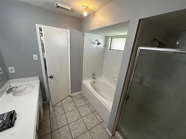 bathroom with vanity, a textured ceiling, tile patterned flooring, and shower with separate bathtub