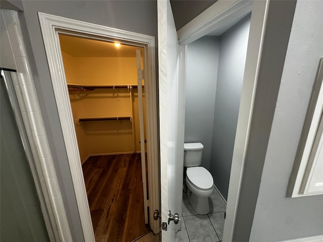 bathroom featuring wood-type flooring and toilet