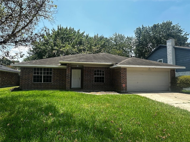 view of front of house with a garage and a front lawn