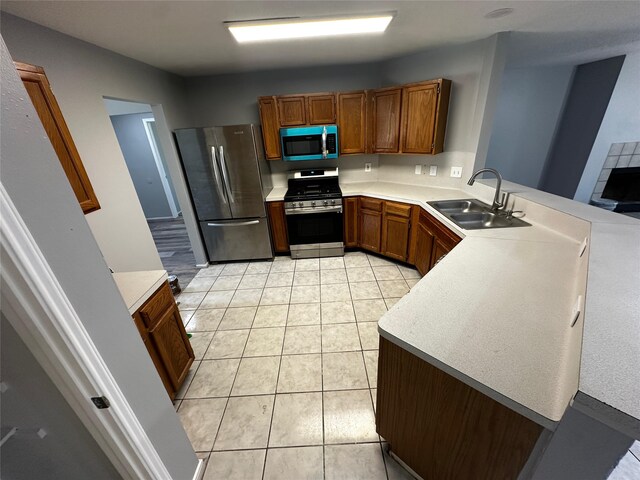 kitchen featuring sink, light tile patterned flooring, and stainless steel appliances