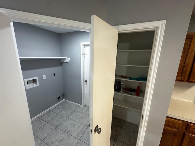 clothes washing area with light tile patterned floors, electric dryer hookup, and washer hookup