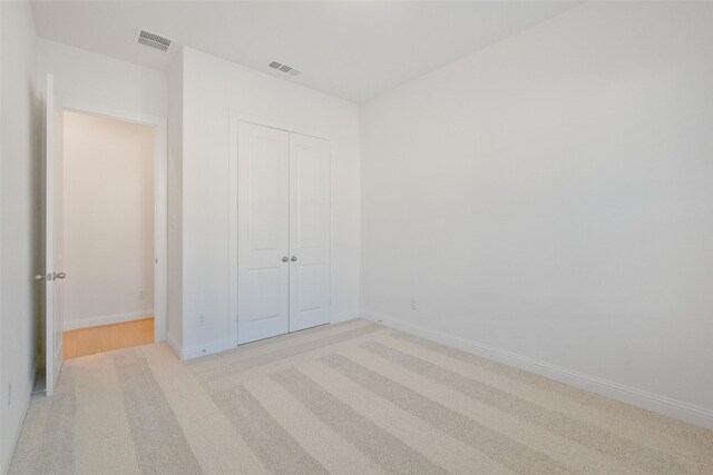 16006 Ruby Laurel Ct, Conroe, TX 77302 - unfurnished bedroom with light carpet, a closet, and baseboards